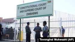 Police officers secure the area outside the Constitutional Court in Harare, Wednesday, Aug, 22, 2018. ((AP Photo/Tsvangirayi Mukwazhi)