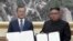 FILE - In this image made from video provided by Korea Broadcasting System (KBS), S. Korean President Moon Jae-in, left, and N. Korean leader Kim Jong Un pose after signing documents in Pyongyang, North Korea Wednesday, Sept. 19, 2018.