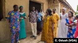 Rebecca Gadzama and schoolteachers survey the aging school building and discuss the upcoming school year.
