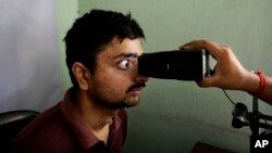 In this May 16, 2012 file photo, an Indian man gets his retina scanned as he enrolls for Aadhar, India's biometric \ID project in Kolkata, India. (AP Photo/Bikas Das, File)