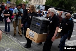 People protest against the outsourcing of jobs by Carrier at a rally hosted by the United Steelworkers and the AFL-CIO at the Statehouse in Indianapolis, Indiana, April 29, 2016.