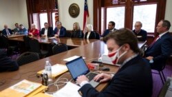 FILE - An "alternate" slate of electors nominated by the Republican Party of Georgia cast their own electoral votes for President Donald Trump at the Georgia State Capitol, Dec. 14, 2020, at the same time the official Democratic electors were casting their votes for Joe Biden in another part of the Capitol.