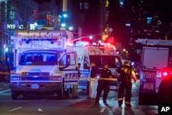 Police and firefighters work near to the scene in Manhattan, New York, Sept. 17, 2016.
