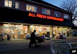 An Orthodox Jewish man walks through the parking lot of a supermarket, March 26, 2019, in Spring Valley, N.Y.