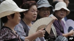 Women rest at a shrine in Tokyo, Japan. (AP Photo/Itsuo Inouye)