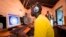 FILE - Young men surf the internet at a cyber cafe on June 20, 2012, in Nairobi, Kenya.