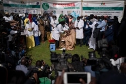 FILE - A health worker administers a dose of China's Sinopharm vaccine to a man during the start of the vaccination campaign against the COVID-19 at the Health Ministry in Dakar, Senegal, Feb. 23, 2021.