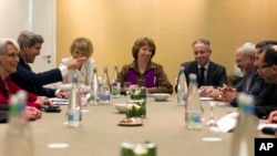 U.S. Secretary of State John Kerry, second left, meets with EU High Representative for Foreign Affairs, Catherine Ashton, center, and Iranian Foreign Minister Mohammad Javad Zarif, third right, at the Iran Nuclear talks in Geneva, Switzerland, Nov. 9, 201