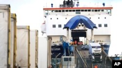 FILE - Lorries and cars disembark from a ferry arriving from Scotland at the P&O ferry terminal in the port at Larne on the north coast of Northern Ireland, Jan. 1, 2021, the first day after Britain's Brexit split with the European Union.