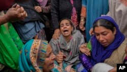 Family members and relatives cry after a boat carrying people including children capsized in Jhelum river on the outskirts of Srinagar, Indian-controlled Kashmir, Tuesday, April. 16, 2024. 