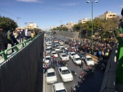 Cars block a street during a protest against a rise in gasoline prices, in the central city of Isfahan, Iran, Nov. 16, 2019.