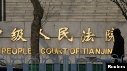 A man walks past the courthouse where prominent rights lawyer Wang Quanzhang is being tried in Tianjin, China December 26, 2018. 