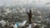 A man searches through trash for food at dump in Libreville. Gabon policymakers say they hope adopting English will attract investment and curb poverty (R. Blackwell/AP)