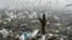 A man searches through trash for food at dump in Libreville. Gabon policymakers say they hope adopting English will attract investment and curb poverty (R. Blackwell/AP)