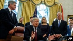 FILE - President Donald Trump answers a reporters question about the investigation of special counsel Robert Mueller during a signing ceremony of the "Cybersecurity and Infrastructure Security Agency Act," in the Oval Office of the White House, Nov. 16, 2018.