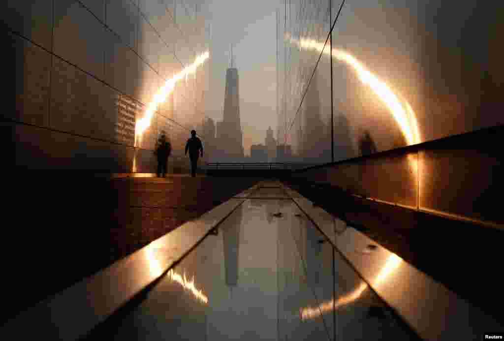 A man walks through the Empty Sky memorial at sunrise across from New York&#39;s Lower Manhattan and One World Trade Center in Liberty State Park in Jersey City, New Jersey, Sept. 11, 2013.&nbsp;