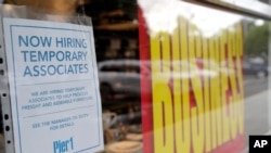A sign advertises hiring of temporary associates at a Pier 1 retail store, which was going out of business, during the coronavirus pandemic, Aug. 6, 2020, in Coral Gables, Fla. 