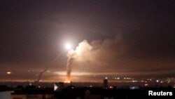 Missile fire is seen from Damascus, Syria, May 10, 2018. Israel said Thursday its fighter jets struck dozens of Iranian military targets inside of Syria overnight in response to what it said were Iranian rocket attacks on Israeli targets in the Golan Heights.