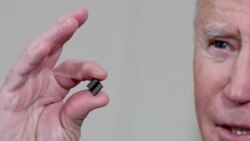 FILE - President Biden holds a semiconductor chip as he speaks prior to signing an executive order, aimed at addressing a global semiconductor chip shortage, in the State Dining Room at the White House, Feb. 24, 2021.