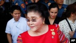  FILE - Former Philippines first lady, Congresswoman Imelda Marcos arrives at the Commission on Elections to support her daughter, Gov. Imee Marcos in filing for the May 2019 midterm elections in Manila, Philippines.