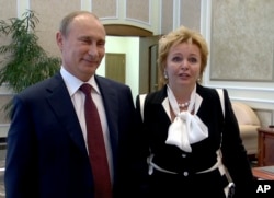 FILE - In this grab made from video provided by the Russia24 TV Channel on June 6, 2013, Russian President Vladimir Putin, left, and his wife, Lyudmila, speak to journalists after attending the ballet "La Esmeralda" in the Kremlin Palace in Moscow, Russia. Putin and his wife announced on state television that they were divorcing.
