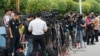 FILE - Journalists gather outside a hospital morgue in Seremban, Negeri Sembilan, Malaysia, Aug. 14, 2019.