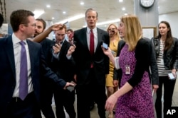 Sen. John Thune, R-S.D., speaks to reporters as he walks toward the Senate as Congress moves closer to the funding deadline to avoid a government shutdown on Capitol Hill in Washington, Jan. 18, 2018.