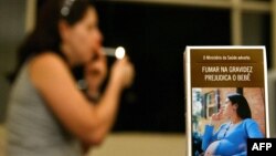 FILE - A Brazilian cigarette pack depicts a photograph of a pregnant smoker with the caption "The Ministry of Health warns: Smoking during pregnancy is detrimental to a child's health."