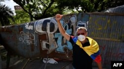Demonstrators block a street with a barricade to protest against a tax reform bill launched by President Ivan Duque, in Cali, Colombia, on May 3, 2021.
