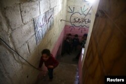 Children are seen in a shelter in the town of Douma in Eastern Ghouta in Damascus, Syria, Feb. 27, 2018.