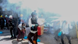 Anti-coup protesters discharge fire extinguishers to counter the impact of the tear gas fired by police during a demonstration in Yangon, Myanmar, Thursday, March 4, 2021. (AP Photo)