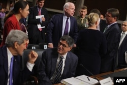 Senate Armed Services Committee Chairman John McCain, center, talks with, from left, Secretary of State John Kerry, Treasury Secretary Jacob Lew, Senator Kirsten Gillibrand, Defense Secretary Ashton Carter and Energy Secretary Ernest Moniz on Capitol Hill