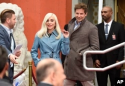 Lady Gaga, left, and Bradley Cooper, co-star's in "A Star Is Born," attend a hand and footprint ceremony honoring actor Sam Elliott at the TCL Chinese Theatre, Jan. 7, 2019, in Los Angeles.