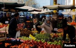 People shop in a bazaar in Ankara, Turkey, March 27, 2019.
