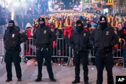 2017年12月31日，纽约曼哈顿的时报广场，新年庆祝活动中，欢庆群众和警察都在严寒中捂得严严实实。