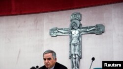 FILE - Cardinal Giovanni Angelo Becciu, caught up in a real estate scandal, speaks to the media a day after he resigned, in Rome, Italy, Sept. 25, 2020. A trial is now underway at the Vatican involving Becciu and nine other defendants. 