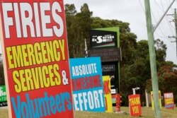 Signs are displayed near Ulludulla, Australia, Jan. 9, 2020, thanking "firies" a colloquial term for firefighters. House after house in affected areas have hung makeshift banners offering thanks to the people they call "firies."