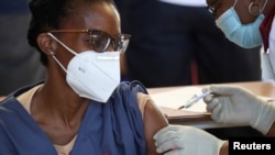 FILE - A health care worker receives the Johnson and Johnson coronavirus disease (COVID-19) vaccination at the Chris Hani Baragwanath Academic Hospital in Soweto, South Africa, Feb. 17, 2021.