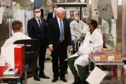Vice President Mike Pence visits the molecular testing lab at Mayo Clinic Tuesday, April 28, 2020, in Rochester, Minn., where he toured the facilities supporting COVID-19 research and treatment. Pence chose not to wear a face mask while touring the…