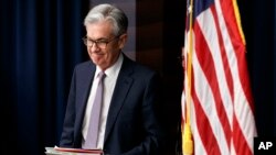 FILE - In this Dec. 11, 2019, file photo Federal Reserve Chair Jerome Powell arrives to speak at a news conference after the Federal Open Market Committee meeting in Washington. 