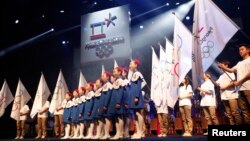 A choir sings as the emblem of the PyeongChang 2018 Olympic Winter Games is seen (top) during its Launch Ceremony in Seoul May 3, 2013. The official emblem of the 2018 PyeongChang Winter Olympic Games was unveiled on Friday.