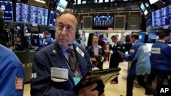 Trader Steven Kaplan works on the floor of the New York Stock Exchange, Feb. 23, 2018.
