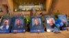 The photos of the killed police officers line the stage during a candle light vigil at City Hall on July 11, 2016, in Dallas.