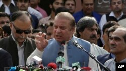 FILE - Nawaz Sharif addresses a crowd during his visit to a mausoleum of Pakistani poet Mohammad Iqbal on the occasion of Pakistan Independence Day in Lahore, Aug. 14, 2017.