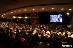 People partake in a viewing party of the broadcast of Britain's Prince Harry and Meghan Markle's royal wedding at the Princess of Wales Theatre in Toronto, Ontario, Canada, May 19, 2018.