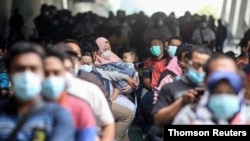 People wait for the COVID-19 vaccine at Juanda International Airport, as cases surge in Sidoarjo, East Java Province, Indonesia July 22, 2021. (Antara Foto/Umarul Faruq/via Reuters)