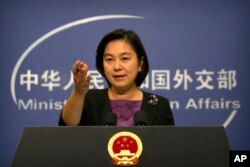 FILE - Chinese foreign ministry spokeswoman Hua Chunying gestures during a press briefing at the Ministry of Foreign Affairs building in Beijing, Sept. 15, 2017.