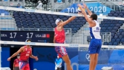 This image shows what men wear during the beach volleyball competition. The players are from the U.S. and Brazil, two countries that started the sport. (AP Photo/Petros Giannakouris)