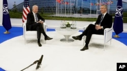 FILE - NATO Secretary-General Jens Stoltenberg speaks with U.S. President Joe Biden on the sidelines of a summit at alliance headquarters in Brussels, June 14, 2021. The two will meet again June 12, 2023, at the White House.
