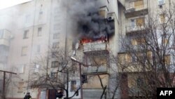 This handout picture taken and released by Ukrainian State Emergency Service on Dec. 26, 2024, shows firefighters putting out a fire after an explosion in a residential building from a Russian shelling in Bilozerka village, Kherson region.